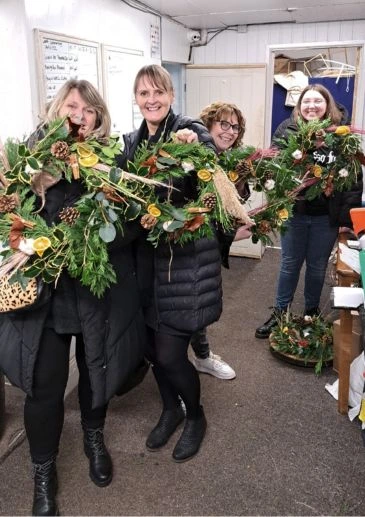 Book a Private small group Christmas wreath workshop where you'll learn traditional techniques for making a door wreath